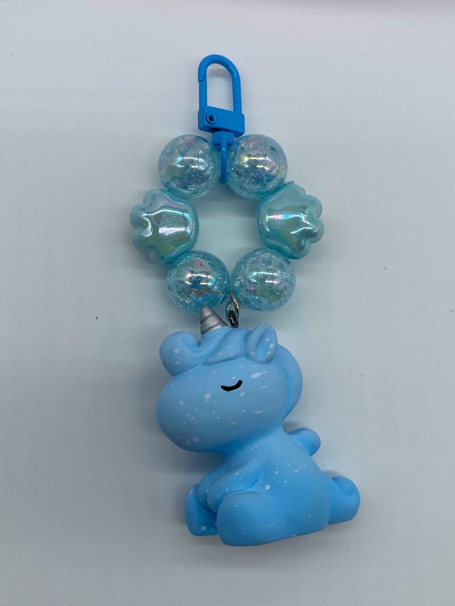 small keychain with a hanging blue unicorn and blue beads